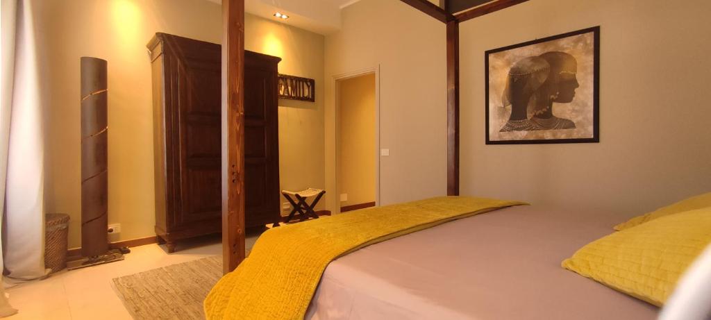 a bedroom with a bed with a yellow blanket at Rota's House III in Bergamo