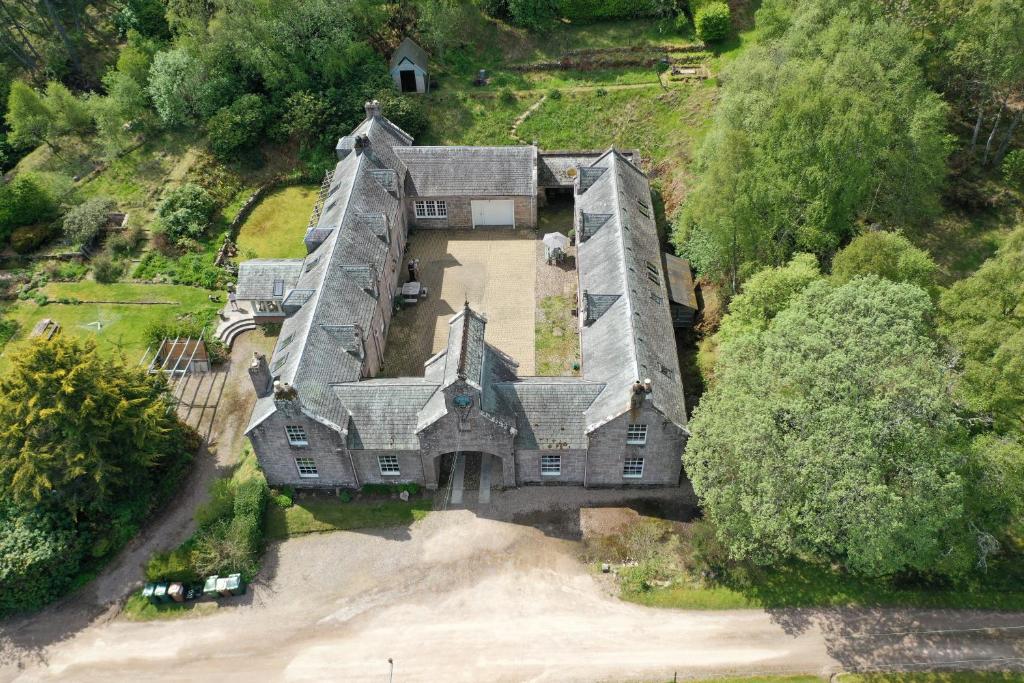 an aerial view of a large house with trees at Coachmans Cottage in Aberlour