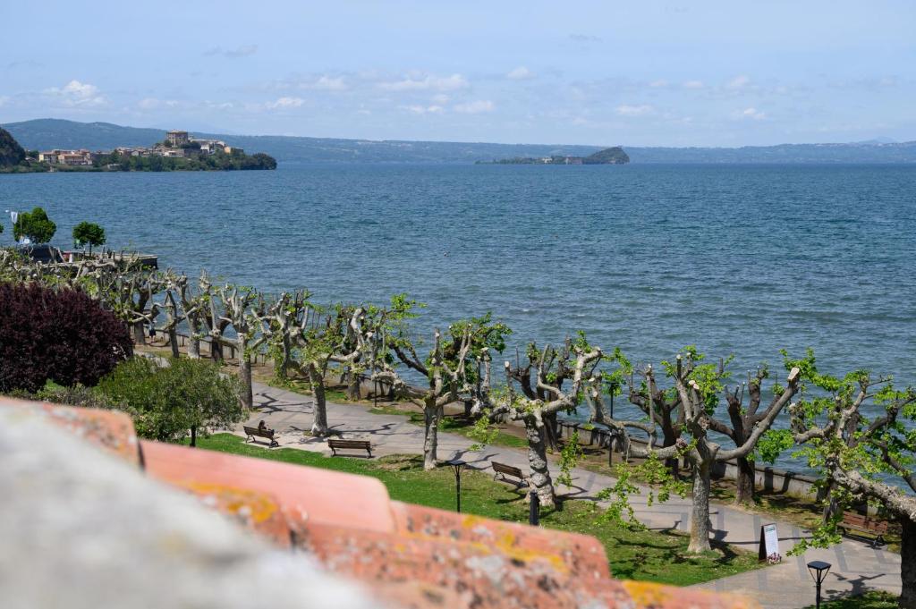 a view of a large body of water with trees at Esmeralda - Mansarda con vista mozzafiato in Marta