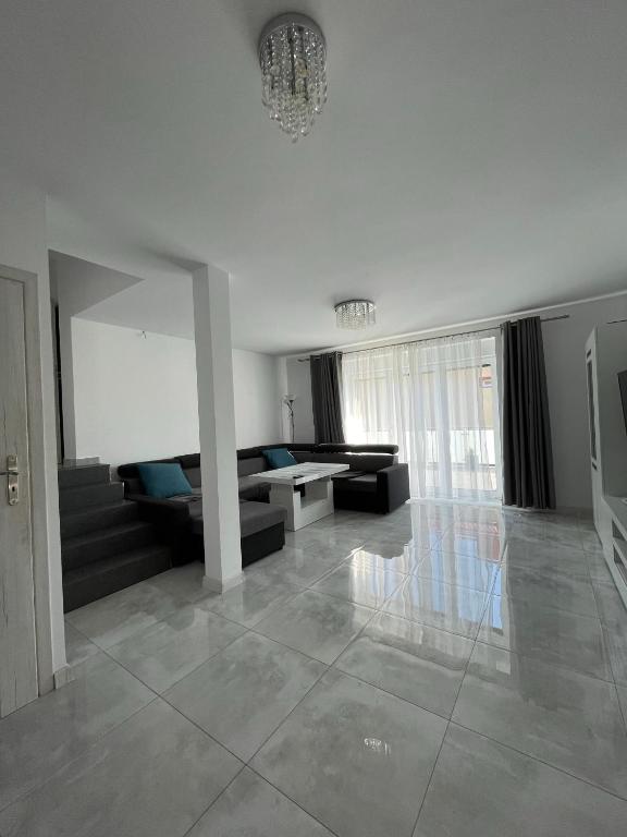 a living room with a couch and a table at Apartament pod Łebą in Charbrowo