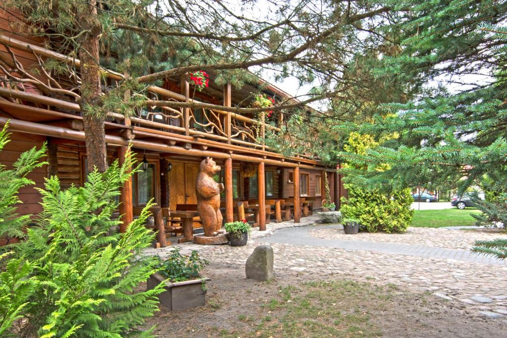 a building with a bear statue in front of it at Dworek Gawra in Białowieża