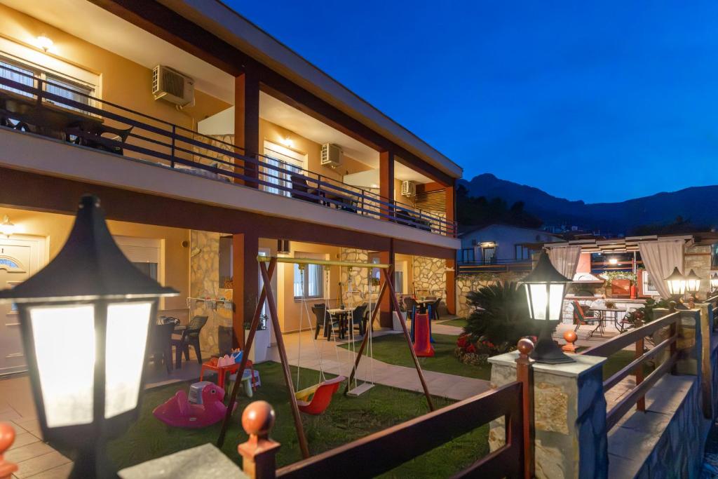 a house with a balcony with a playground at Antigone View Apartments in Skala Potamias