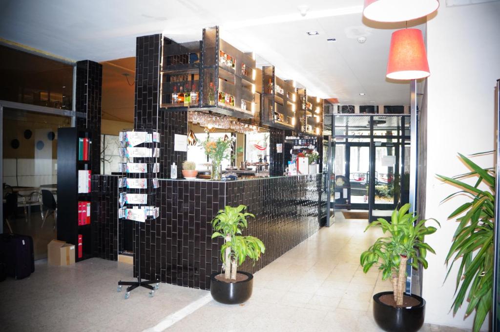 a store with two potted plants in a room at Escale Hotel in Brussels