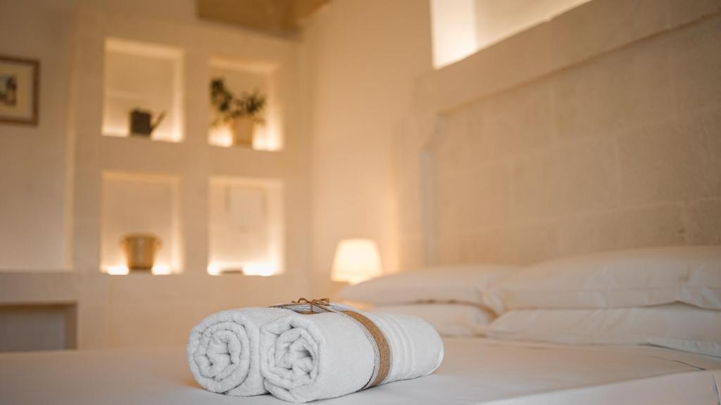 Postel nebo postele na pokoji v ubytování San Lorenzo Camere&Suites