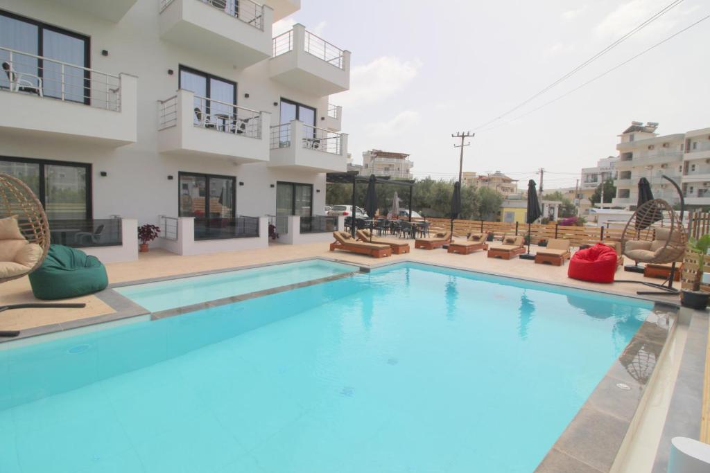 a large swimming pool in front of a building at Noa Boutique Hotel in Ksamil