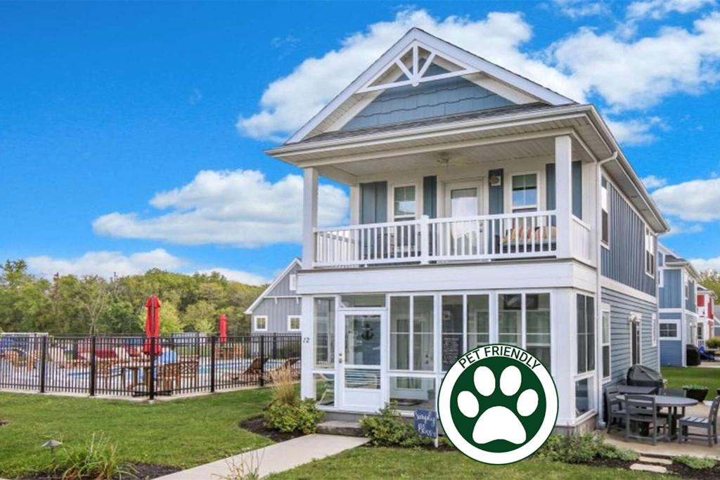 a white house with a balcony and a fence at Splash Haven in Ottawa