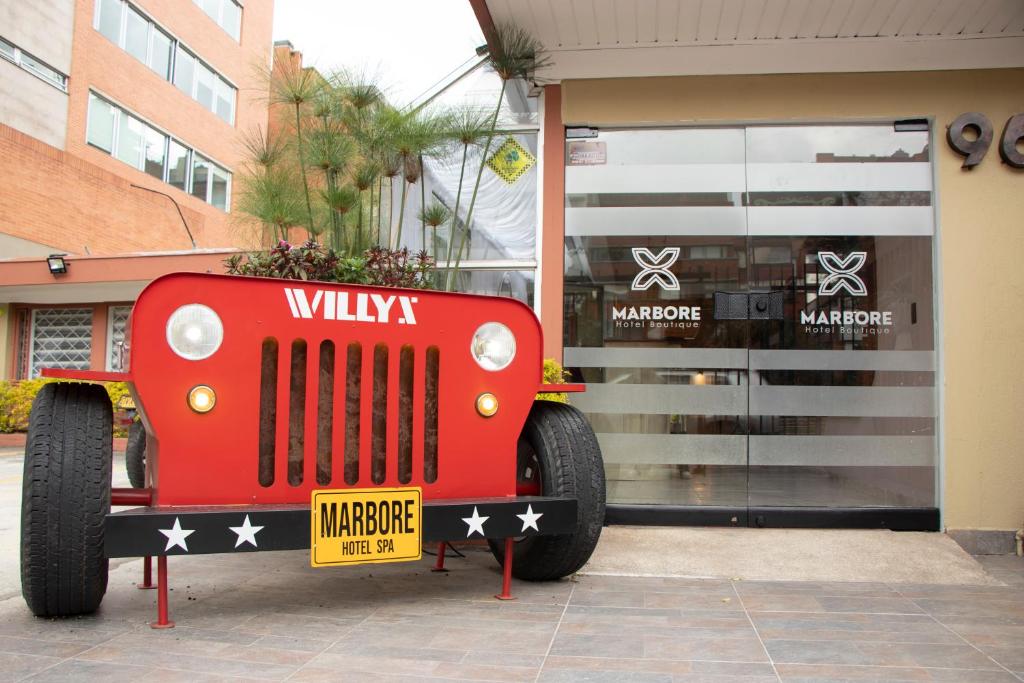 a red car on display in front of a store at Marbore hotel & Spa in Bogotá