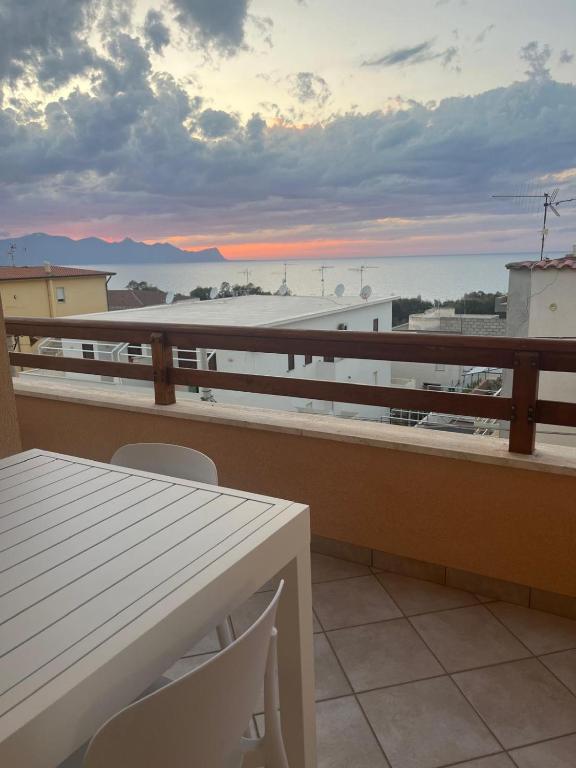 a balcony with a table and a view of the ocean at Profumo di Mare 2 in Alcamo Marina