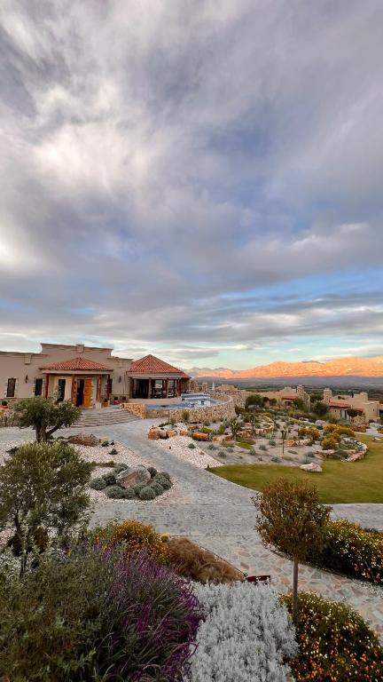 a view of a building with a garden at Piattelli Wine Resort Hotel Cafayate in Cafayate