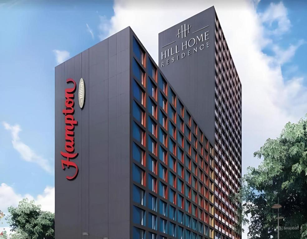 a building with a sign on the side of it at Aparthotel Hilton Blox in Tbilisi City