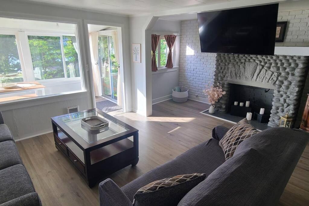 a living room with a couch and a fireplace at Bay View Casita in Olympia