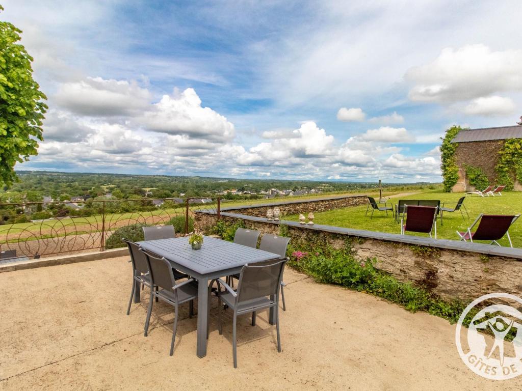 a table and chairs on a patio with a view at Gîte paisible au cœur des vignobles avec jardin et parking privatif - FR-1-622-3 in Rochefort-sur-Loire