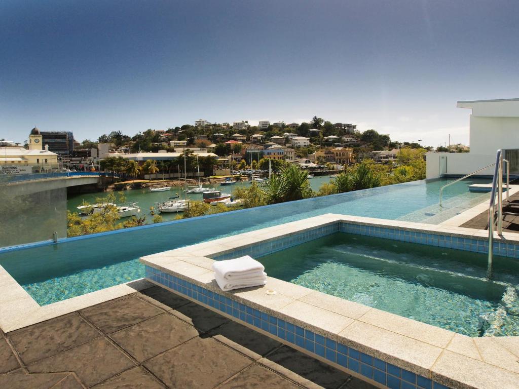 a swimming pool on top of a building at Oaks Townsville Gateway Suites in Townsville