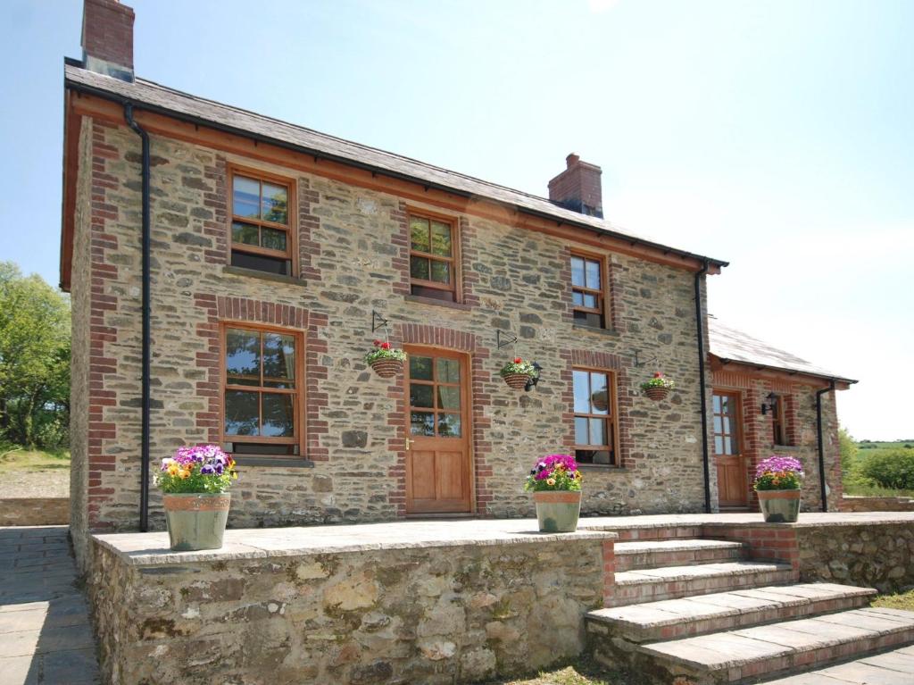 a stone building with stairs in front of it at 3 Bed in New Quay LLWYD in Pencader