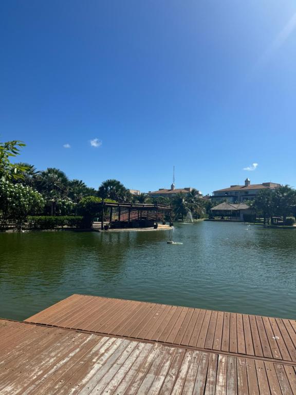 a view of a river with a wooden dock at Golf Ville Resort in Aquiraz