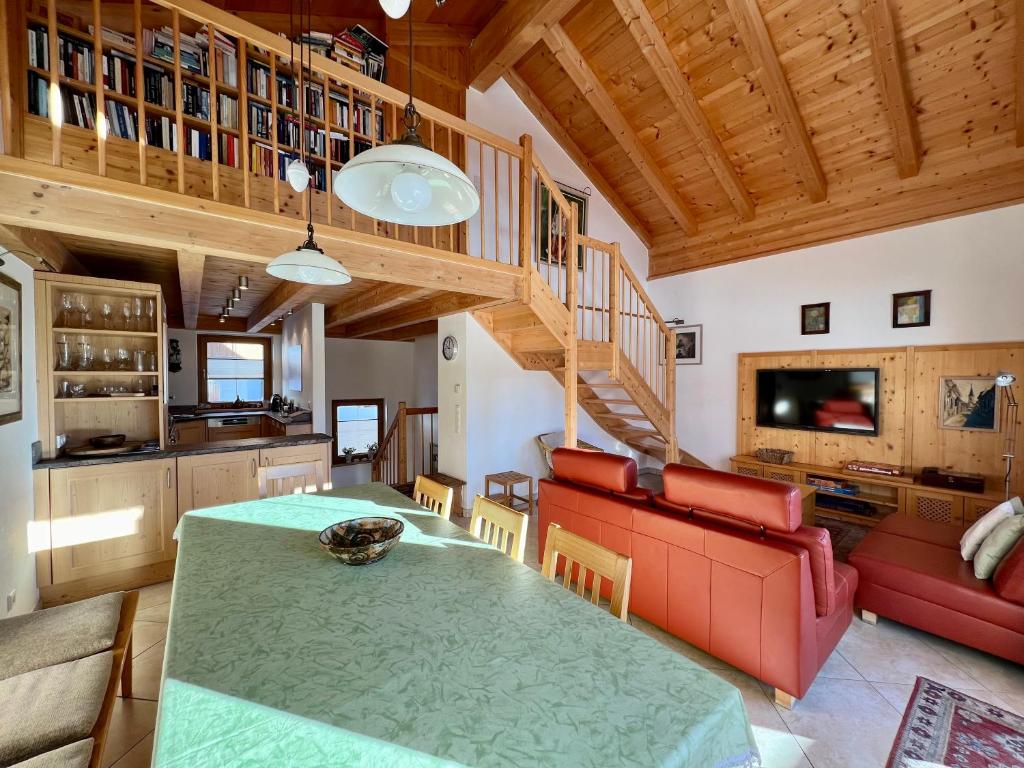 a kitchen and living room with a table and a couch at Almhäuser Filzsteinalpe Almhaus 206 in Krimml