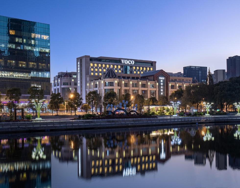 a view of the vox building at night at voco Wuhan Xinhua, an IHG Hotel in Wuhan