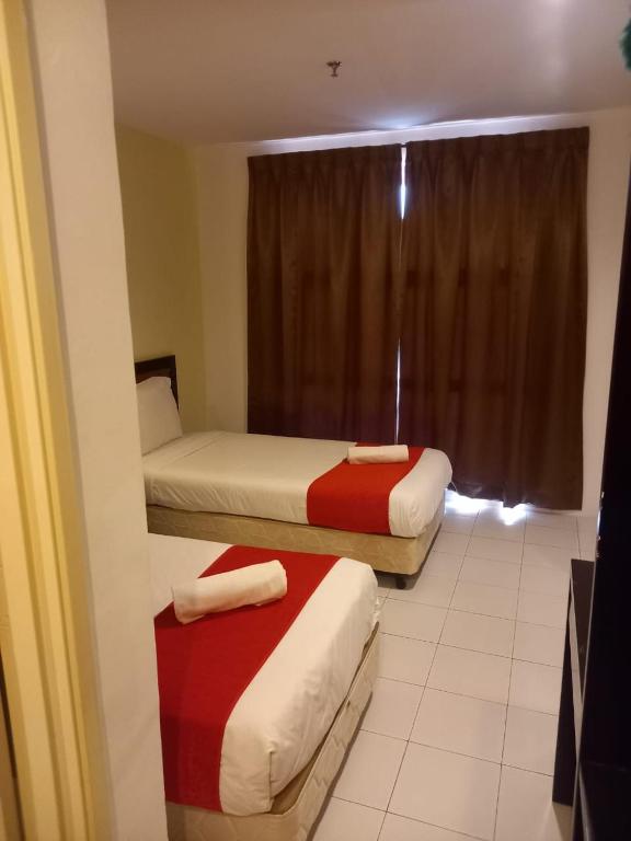 Postel nebo postele na pokoji v ubytování Syajie Koptown Hotel
