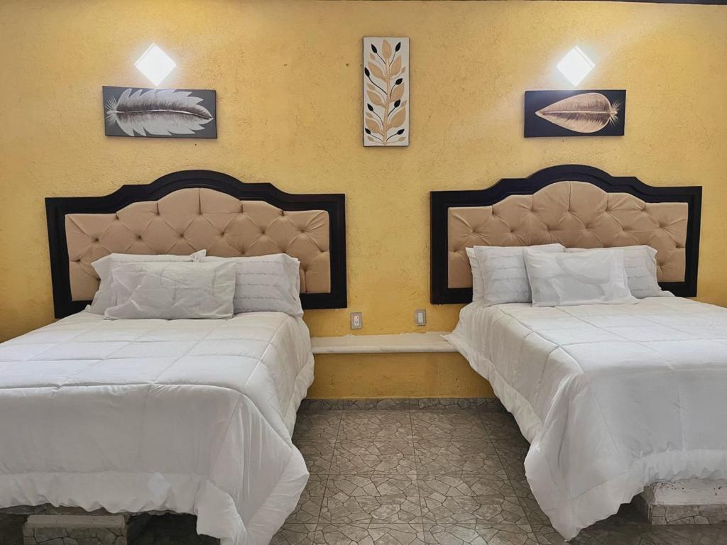 Postel nebo postele na pokoji v ubytování Hotel Peña Florencia
