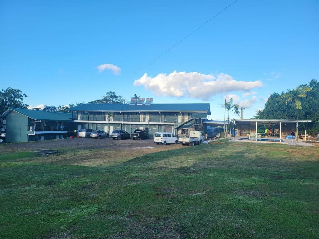 a large building with cars parked in front of it at Moalela'i Accommodation in Apia