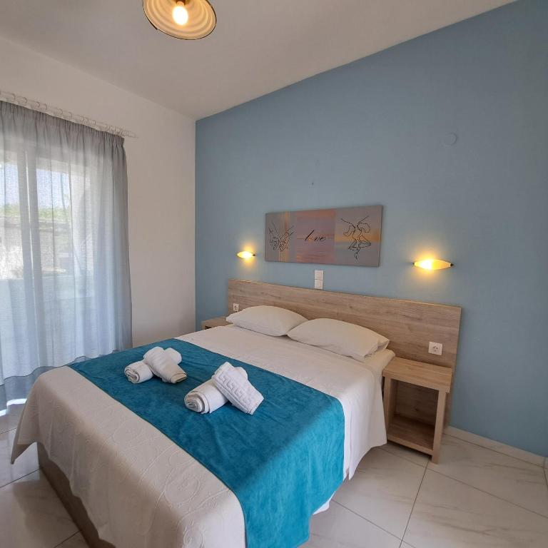 a bedroom with a large bed with towels on it at Studio Stars in Laganas