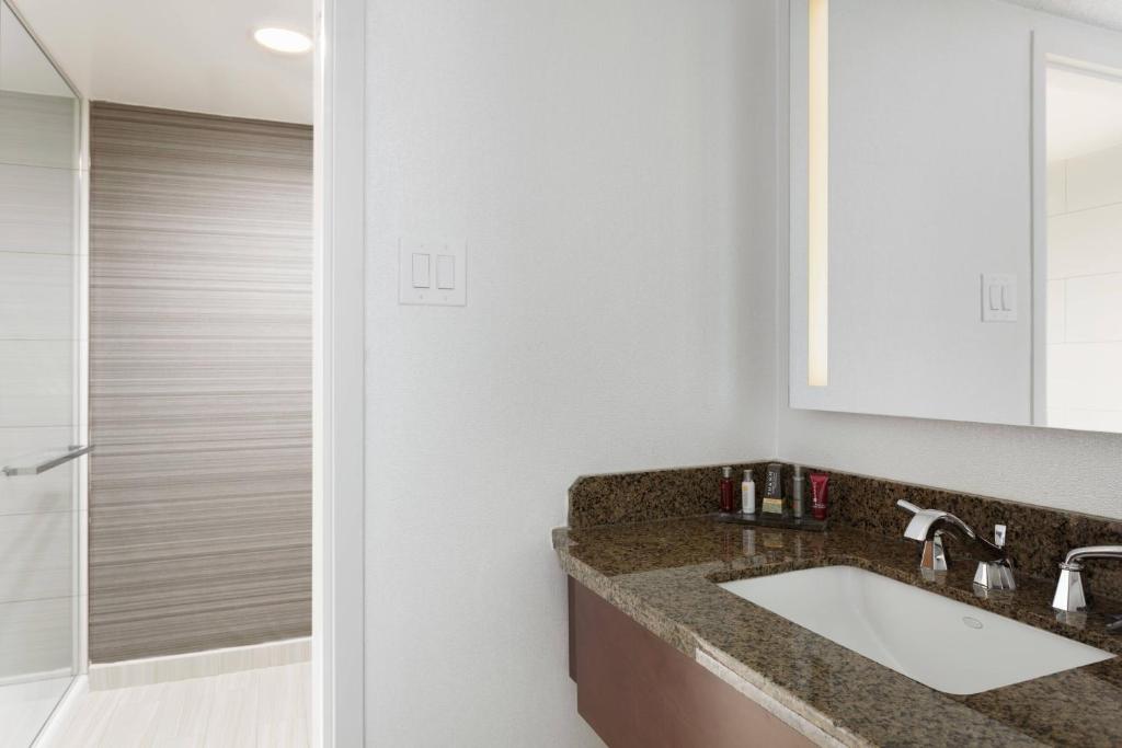 a bathroom with a sink and a shower at Newark Liberty International Airport Marriott in Newark