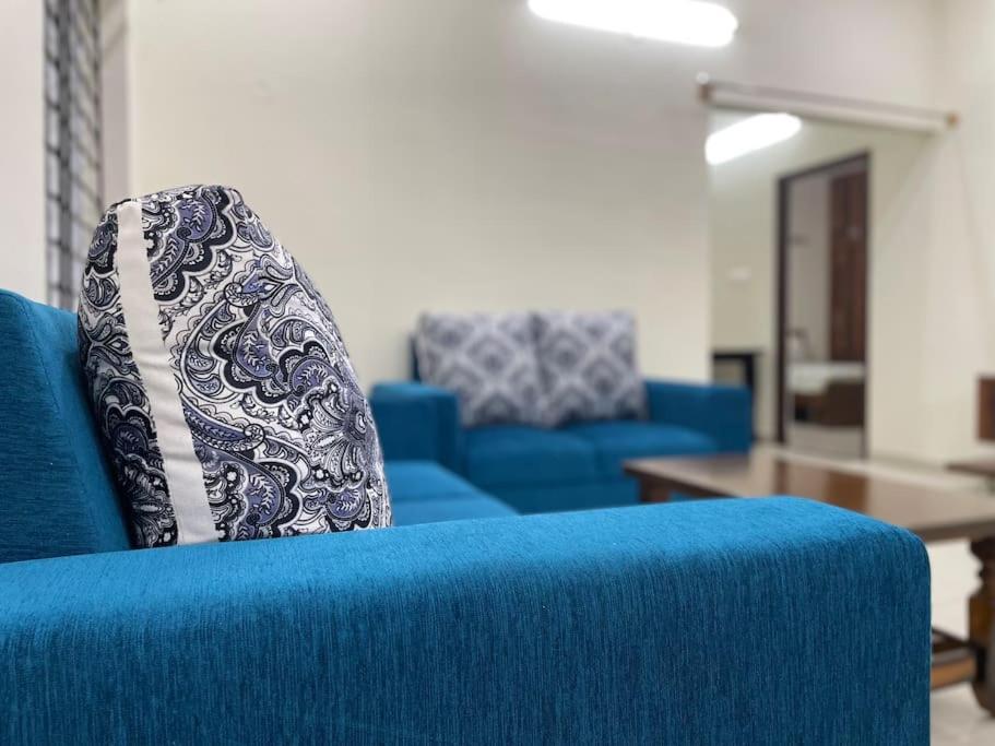 a blue couch with a pillow on top of it at SSN Home Stays in Bangalore near PLAY Arena in Bangalore