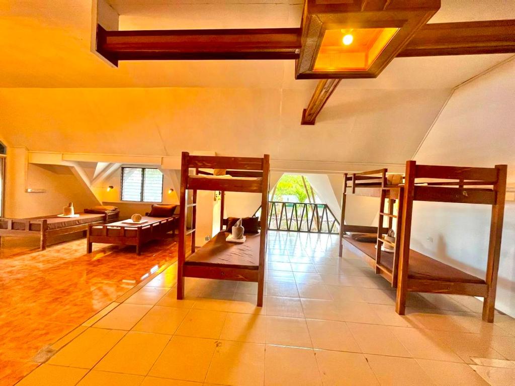 um quarto com 2 beliches e uma sala de estar em On Board Panglao Beach Hostel & Resort em Dao