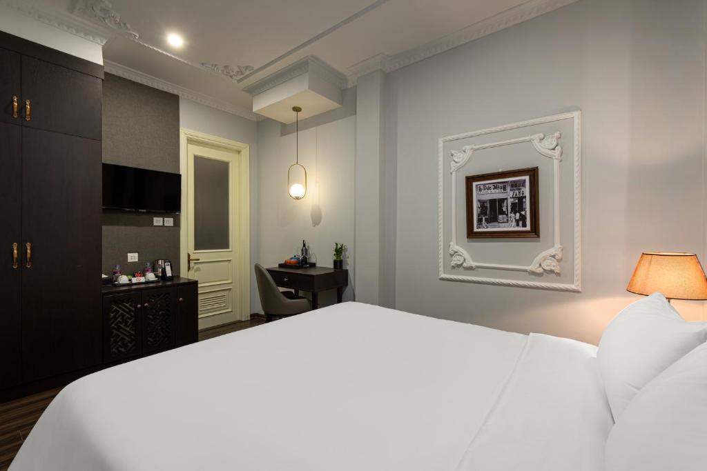 Postel nebo postele na pokoji v ubytování Avani Central Hanoi Hotel