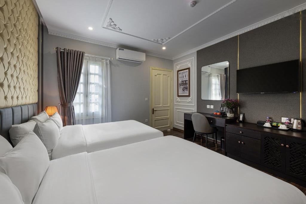 Postel nebo postele na pokoji v ubytování Avani Central Hanoi Hotel