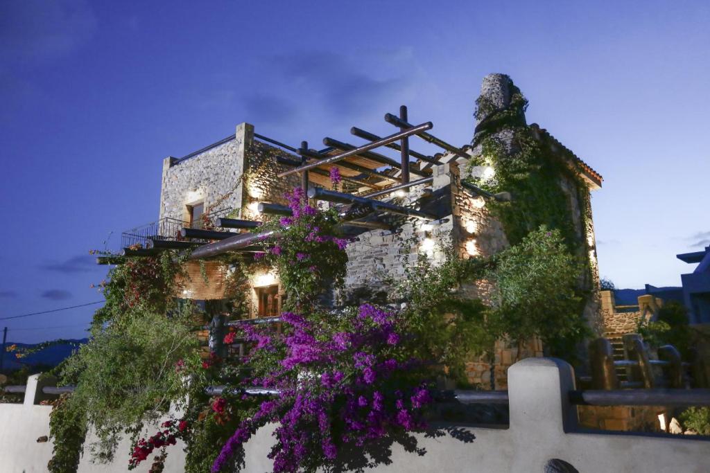 a building with flowers on the side of it at Astrolithos Boutique in Monemvasia