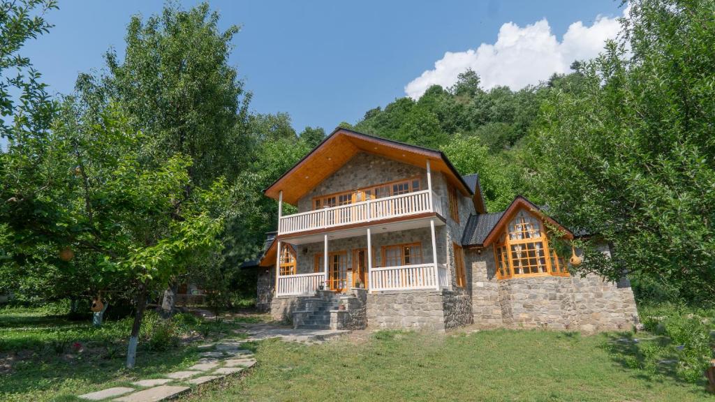 a house on a hill with trees at Somvan Chalet by Mick-Hans in Baragrān