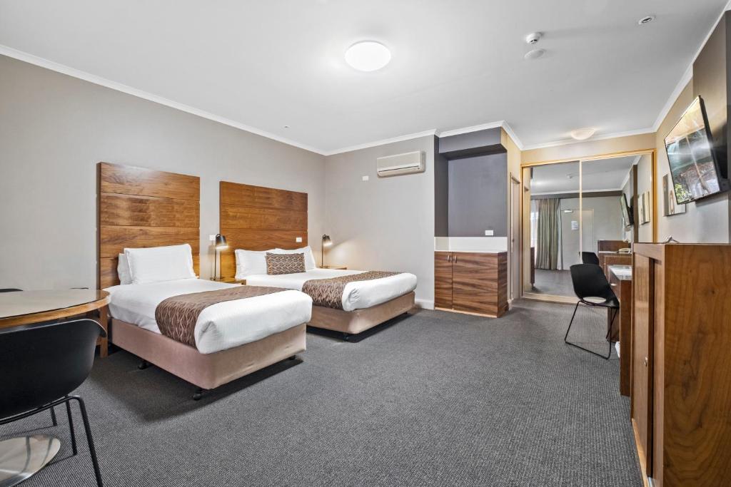 Postel nebo postele na pokoji v ubytování Quality Hotel Dickson