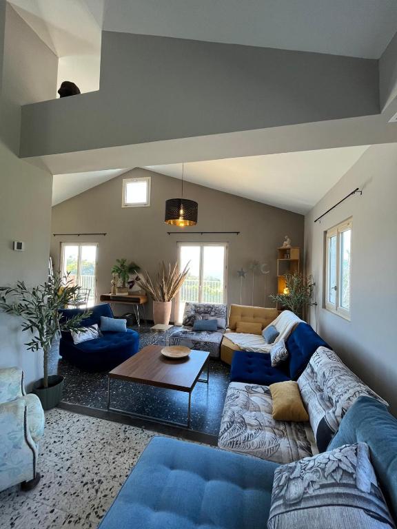 un salon avec des canapés bleus et une table dans l'établissement Magnifique! Idéal!, à Grosseto-Prugna