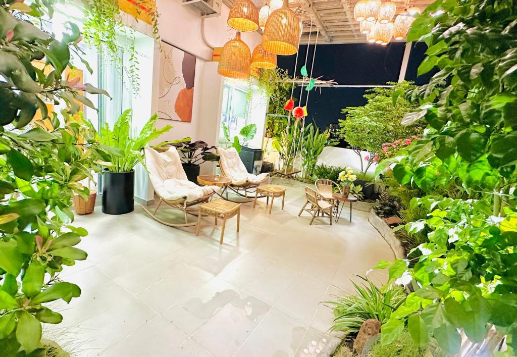a room filled with lots of plants and chairs at Skyline Penthouse Greenery in Ho Chi Minh City