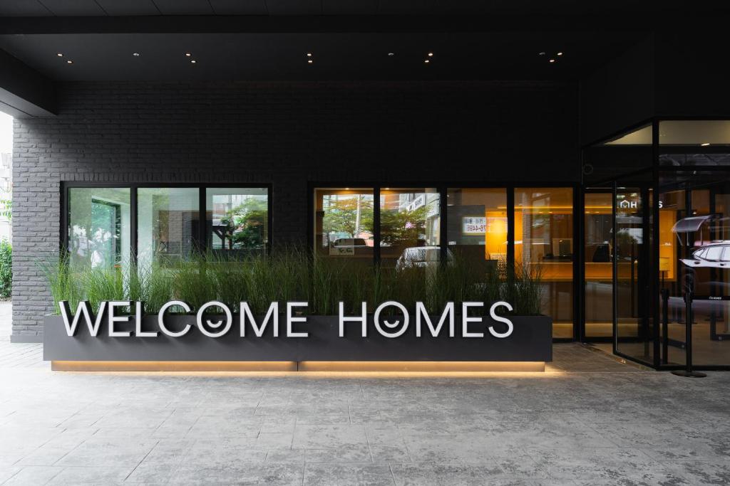 a welcome homes sign in front of a building at Homes Stay G-Valley Gasan in Seoul