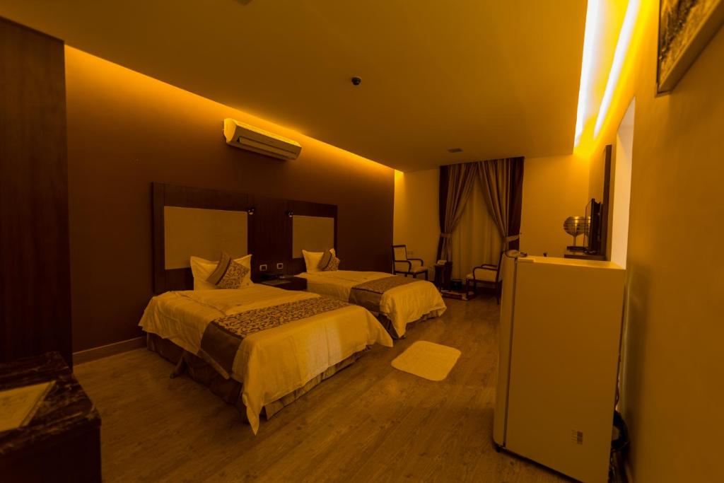 Postel nebo postele na pokoji v ubytování رؤوم ان للشقق الفندقية-Raoum Inn Hotel Apartments