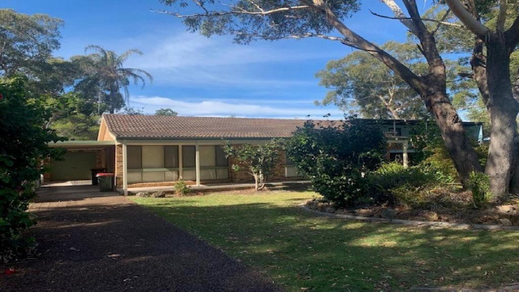 a house with a garden in front of it at Hawks Nest's Holiday Gem in Hawks Nest