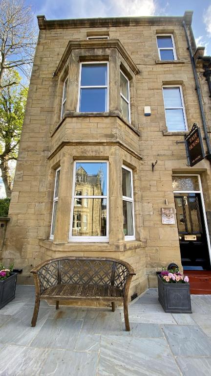 a bench in front of a building with a window at Tate House in Alnwick