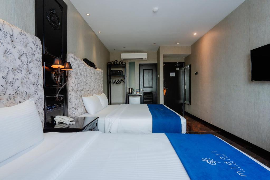 Postel nebo postele na pokoji v ubytování Midori Concept Hotel