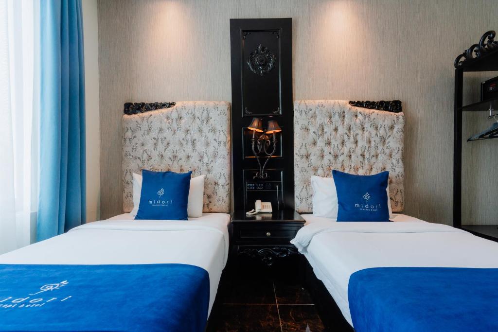 Postel nebo postele na pokoji v ubytování Midori Concept Hotel