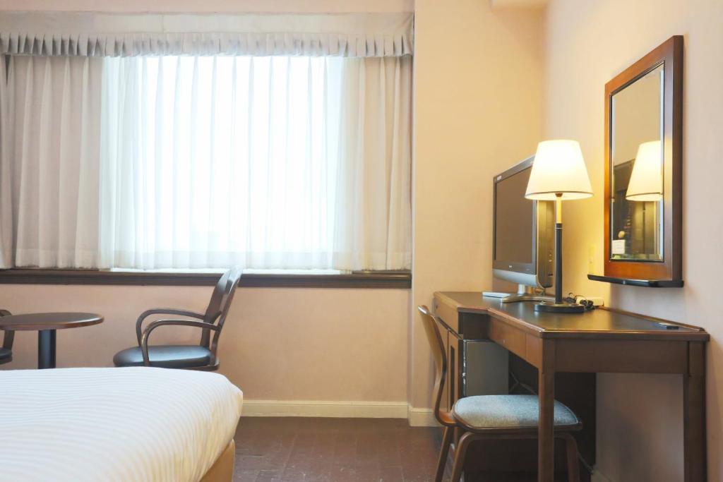 Postel nebo postele na pokoji v ubytování Hotel Castle Inn Tsu