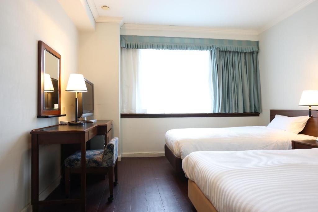 Postel nebo postele na pokoji v ubytování Hotel Castle Inn Tsu