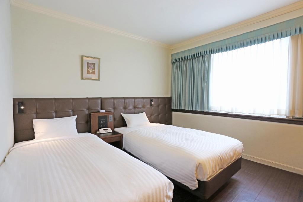Postel nebo postele na pokoji v ubytování Hotel Castle Inn Tsu