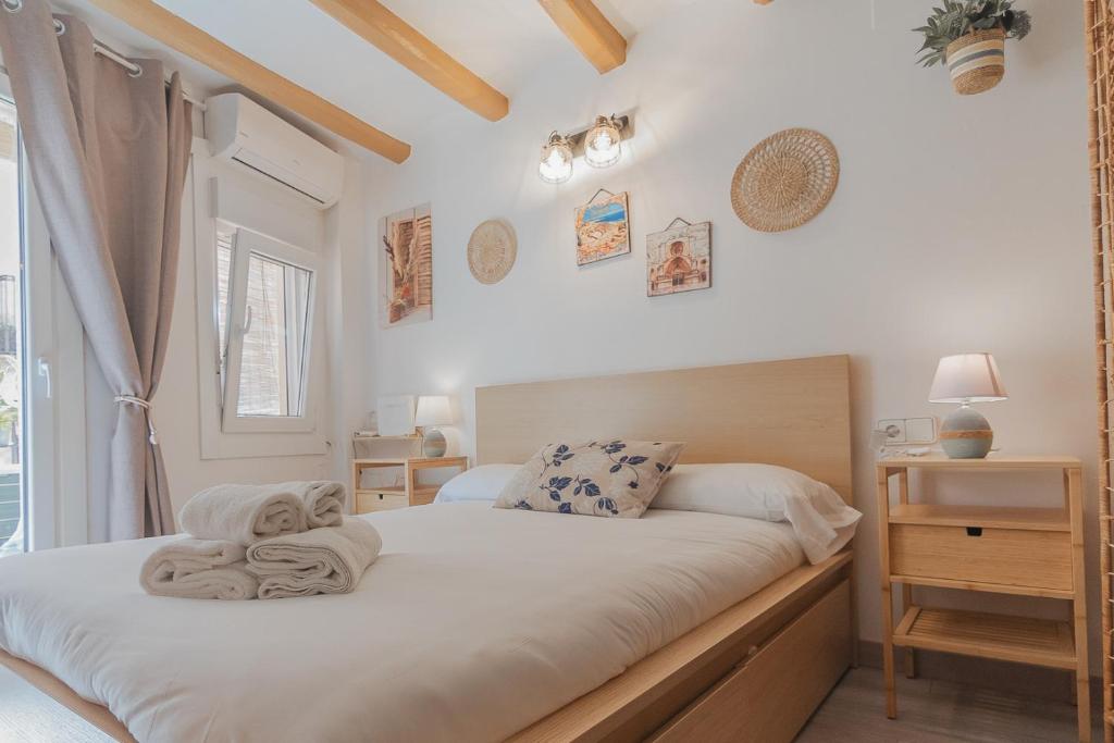 a bedroom with a bed with towels on it at Sweet Sedassos in Tarragona
