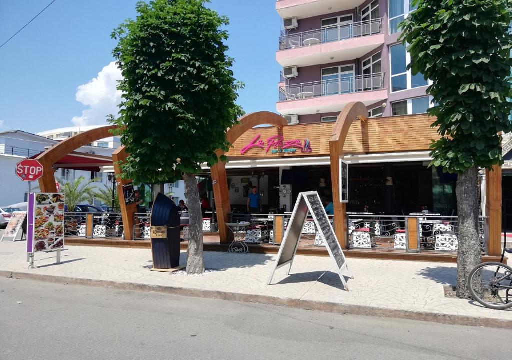 a store with a sign in front of a building at Kims One-bed Apart for rent at Sunny Beach Resort in Sunny Beach