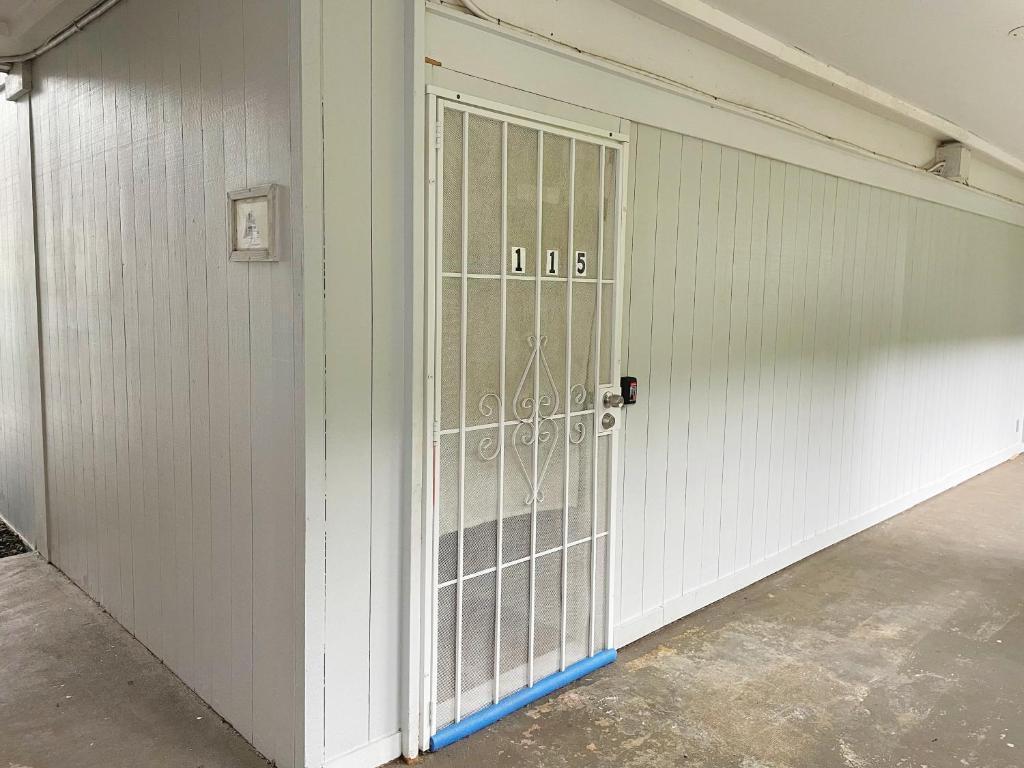 an empty garage with a door with the number at Studio in Hilo Center with Pool and Lake Views in Hilo