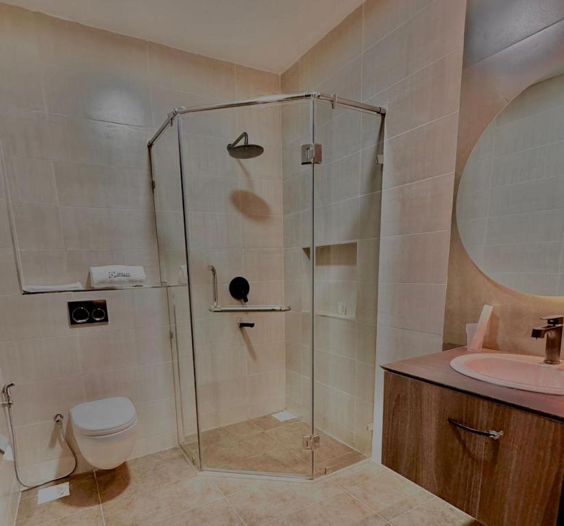 a bathroom with a shower and a toilet and a sink at The Ivory Hotel in Nairobi