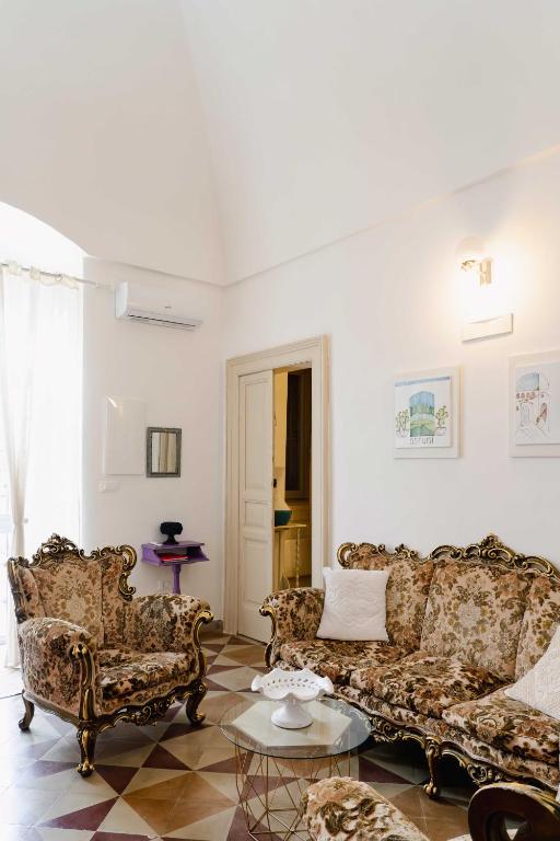 a living room with two couches and a table at Masseria della Piana in Villanova di Ostuni