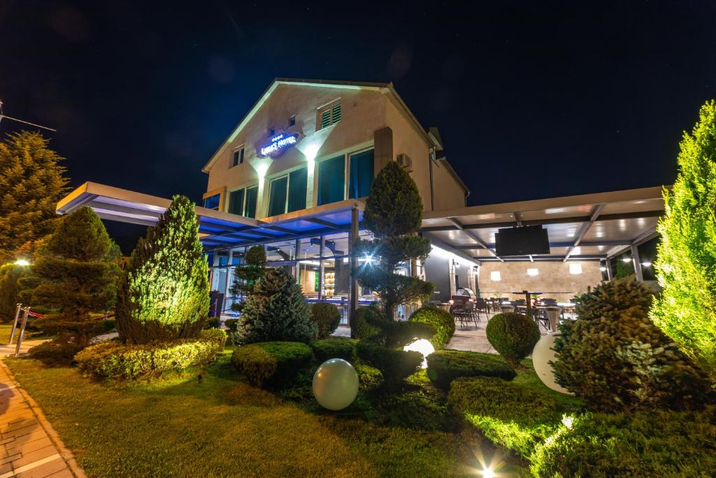 un edificio con jardín por la noche en Hotel Luka's en Berane